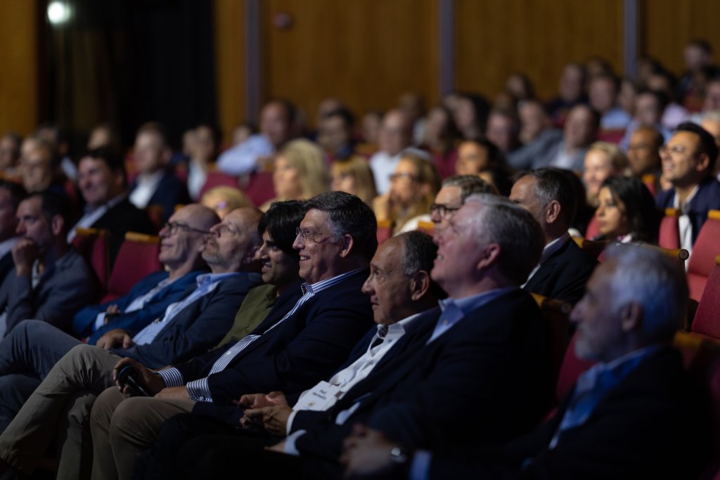 A group of people sitting in a row.