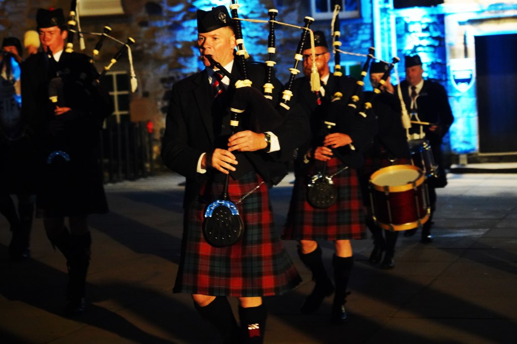 A group of men playing bagpipes.